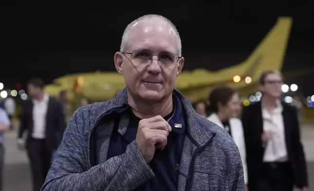 Paul Whelan shows a pin he received from President Joe Biden as he arrives at Kelly Field after being released by Russia, Friday, Aug. 2, 2024, in San Antonio. (AP Photo/Eric Gay)