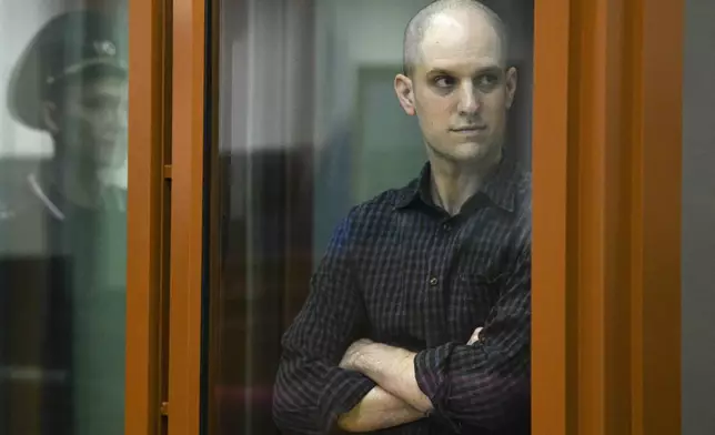 FILE - Wall Street Journal reporter Evan Gershkovich stands in a glass defendant's booth in a courtroom in Yekaterinburg, Russia, on June 26, 2024. (AP Photo, File)