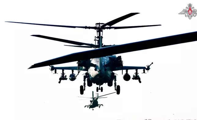 In this photo taken from video released by the Russian Defense Ministry on Sunday, Aug. 11, 2024, Ka-52 helicopters gunships of the Russian air force take off to air strike on concentrations of manpower, armored vehicles and automobile military equipment of the Ukrainian Armed Forces in the border area of the Kursk region. (Russian Defense Ministry Press Service via AP)