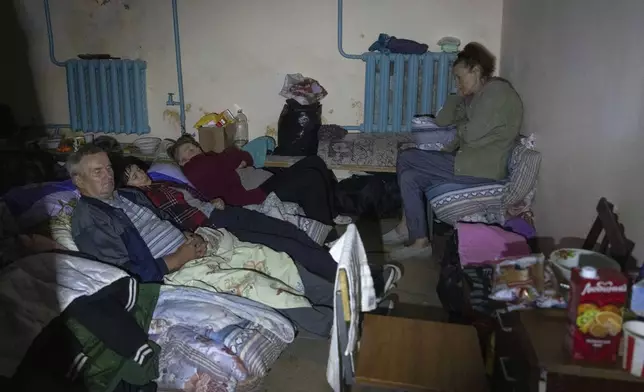 Local residents hide in a basement in Sudzha, Kursk region, Russia, Friday, Aug. 16, 2024. This image was approved by the Ukrainian Defense Ministry before publication. (AP Photo)