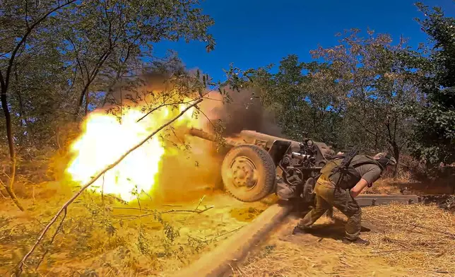 In this photo taken from a video released by the Russian Defense Ministry on Thursday, Aug. 22, 2024, a Russian soldier fires from D-30 howitzer towards Ukrainian positions in an undisclosed location in Ukraine. (Russian Defense Ministry Press Service via AP)