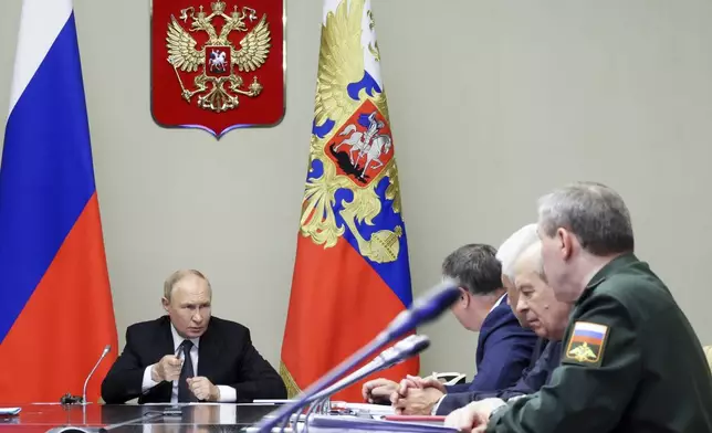 Russian President Vladimir Putin, left, leads a meeting with top security and defense officials about the situation in Kursk and Belgorod border regions, at Novo-Ogaryovo state residence outside of Moscow, Russia, Monday, Aug. 12, 2024. (Gavriil Grigorov, Sputnik, Kremlin Pool Photo via AP)