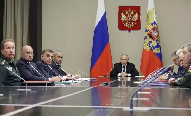 Russian President Vladimir Putin, center, leads the meeting with top security and defence officials dedicated to the situation in Kursk and Belgorod border regions, at Novo-Ogaryovo state residence outside of Moscow, Russia, Monday, Aug. 12, 2024. (Gavriil Grigorov, Sputnik, Kremlin Pool Photo via AP)