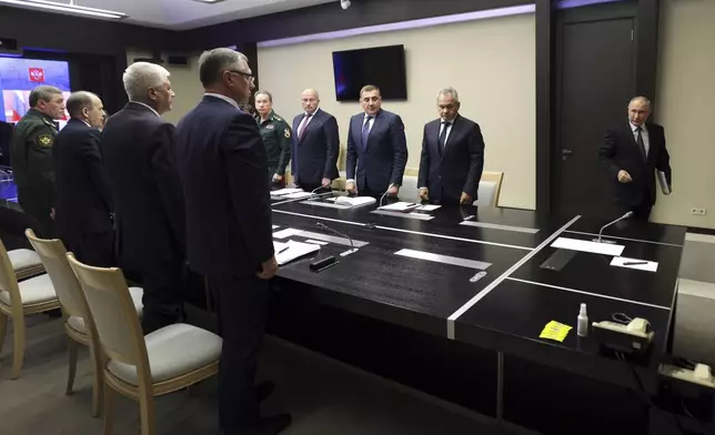 Russian President Vladimir Putin, right, leads the meeting with top security and defence officials dedicated to the situation in Kursk and Belgorod border regions, at Novo-Ogaryovo state residence outside of Moscow, Russia, Monday, Aug. 12, 2024. (Gavriil Grigorov, Sputnik, Kremlin Pool Photo via AP)