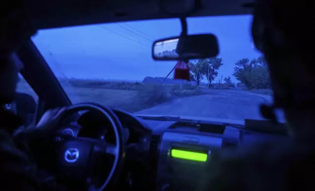 Ukrainian servicemen of 148th separate artillery brigade of the Air Assault Forces drive towards their positions at the frontline in Donetsk region, Ukraine, Wednesday, August 21, 2024. (AP Photo/Evgeniy Maloletka)