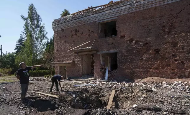 Serhii Zaichenko, 63, school guard shows his school which was heavily damaged after Russian airstrike in Mohrytsia, near Russian-Ukrainian border, Sumy region, Ukraine, Wednesday, Aug. 14, 2024. Zaichenko said two people were killed, including one child. (AP Photo/Evgeniy Maloletka)