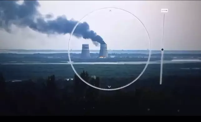 In this image from a surveillance camera provided by the Ukrainian Presidential Press Office, smoke rises from a cooling tower of the Zaporizhzhia Nuclear Power Station in a Russia-controlled area in the Energodar, Zaporizhzhia region of Ukraine, Sunday, Aug. 11, 2024. (Ukrainian Presidential Press Office via AP)