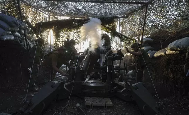 Ukrainian servicemen of 148th separate artillery brigade of the Air Assault Forces fire towards Russian positions by a M777 howitzer at the frontline in Donetsk region, Ukraine, Wednesday, August 21, 2024. (AP Photo/Evgeniy Maloletka)