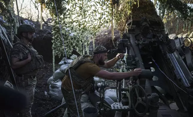 Ukrainian serviceman of 148th separate artillery brigade of the Air Assault Forces prepare his M777 howitzer before firing towards Russian positions at the frontline in Donetsk region, Ukraine, Wednesday, August 21, 2024. (AP Photo/Evgeniy Maloletka)