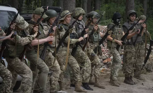 Volunteers for mobile units responsible for shooting down Russian drones receive combat training in the Bucha region, near Kyiv, Ukraine, Aug. 3, 2024. (AP Photo/Efrem Lukatsky)