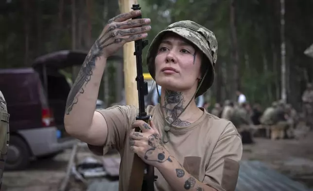 A volunteer for an air-defense unit receives combat training in the Bucha region, near Kyiv, Ukraine, Aug. 3, 2024. (AP Photo/Efrem Lukatsky)