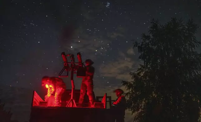 A volunteer for an air-defense unit prepares a machine gun near Bucha, Kyiv region, Ukraine, Aug. 9, 2024. (AP Photo/Evgeniy Maloletka)