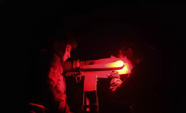 Volunteers for an air-defense unit prepare a machine gun near Bucha, Kyiv region, Ukraine, Aug. 9, 2024. (AP Photo/Evgeniy Maloletka)