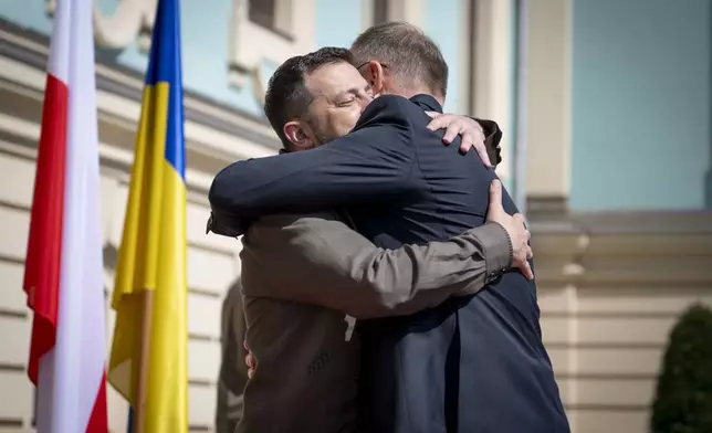 In this photo provided by the Ukrainian Presidential Press Office, Polish President Andrzej Duda, right, is being greeted by Ukrainian President Volodymyr Zelenskyy in Kyiv, Ukraine, Saturday, Aug. 24, 2024. (Ukrainian Presidential Press Office via AP)