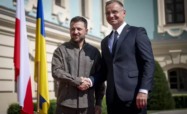 In this photo provided by the Ukrainian Presidential Press Office, Polish President Andrzej Duda, is being greeted by Ukrainian President Volodymyr Zelenskyy in Kyiv, Ukraine, Saturday, Aug. 24, 2024. (Ukrainian Presidential Press Office via AP)