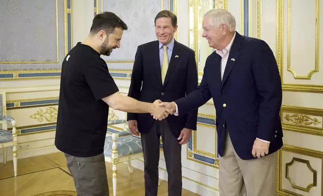 In this photo provided by the Ukrainian Presidential Press Office, Ukrainian President Volodymyr Zelenskyy, left, shakes hands with US Sen. Lindsey Graham (R-S.C.) as US Sen. Richard Blumenthal, D-Conn. Looks on in Kyiv, Ukraine, Monday, Aug. 12, 2024. (Ukrainian Presidential Press Office via AP)