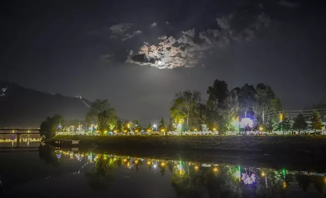 Clouds float past a supermoon over the Jhelum River in Srinagar, Indian controlled Kashmir, Monday, Aug. 19, 2024. (AP Photo/Mukhtar Khan)