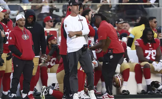 San Francisco 49ers head coach Kyle Shanahan, middle, watches from the sideline during the second half of a preseason NFL football game against the New Orleans Saints in Santa Clara, Calif., Sunday, Aug. 18, 2024. (AP Photo/Jed Jacobsohn)