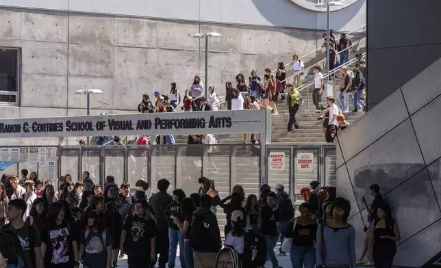 Students leave for the day the Ramon C. Cortines School of Visual and Performing Arts High School in downtown Los Angeles on Tuesday, Aug. 13, 2024. (AP Photo/Damian Dovarganes)