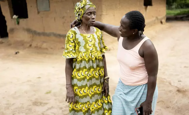 Coach Isabelle Sambou, 43 years old, two-time Olympian and nine-time African wrestling champion, right, talks with her aunt Awa Sy, a former wrestler, in Mlomp, southern Senegal, Wednesday, July 10, 2024. (AP Photo/Sylvain Cherkaoui)