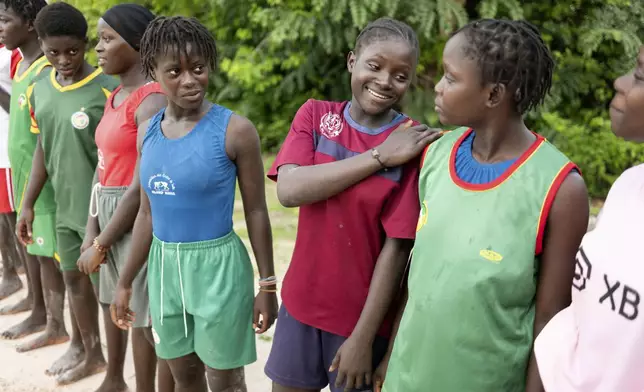 Young women coached by Isabelle Sambou, two-time Olympian and nine-time African wrestling champion, wait before a wrestling training in Mlomp, southern Senegal, Wednesday, July 10, 2024. (AP Photo/Sylvain Cherkaoui)