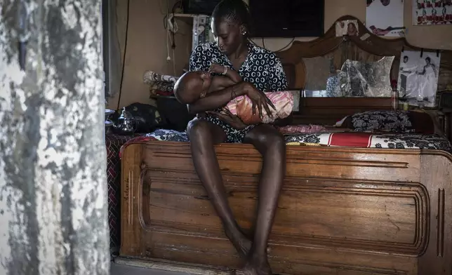 Salamba Ndeye, a 28-year-old who tried to migrate to Europe twice, is photographed in her family house in Thiaroye-Sur-Mer, Senegal, Friday, Aug. 23, 2024. Salamba is one of thousands of young Senegalese who try to flee poverty and the lack of job opportunities in the West African country each year to head to Spain. More than 22,300 people have landed on the Canary Islands from January to mid-August this year. (AP Photo/Annika Hammerschlag)