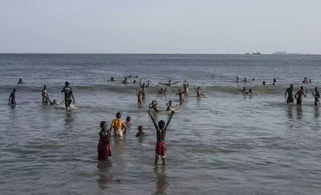 Youths play at the beach in Thiaroye-Sur-Mer, Senegal, Friday, Aug. 23, 2024. Migrants leave on artisanal fishing boats known as pirogues and navigate for several days against strong winds and Atlantic currents. While thousands have survived the risky journey, many die or disappear along the way with remains sometimes washing up on the other side of the Atlantic. (AP Photo/Annika Hammerschlag)