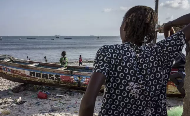 Salamba Ndeye, a 28-year-old who tried to migrate to Europe twice, is photographed at the beach in Thiaroye-Sur-Mer, Senegal, Friday, Aug. 23, 2024. Salamba is one of thousands of young Senegalese who try to flee poverty and the lack of job opportunities in the West African country each year to head to Spain. More than 22,300 people have landed on the Canary Islands from January to mid-August this year, (AP Photo/Annika Hammerschlag)