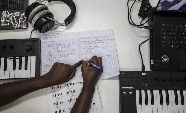 A student takes notes at a beat making class for women in Dakar, Senegal, Wednesday, Aug. 14, 2024. (AP Photo/Annika Hammerschlag)