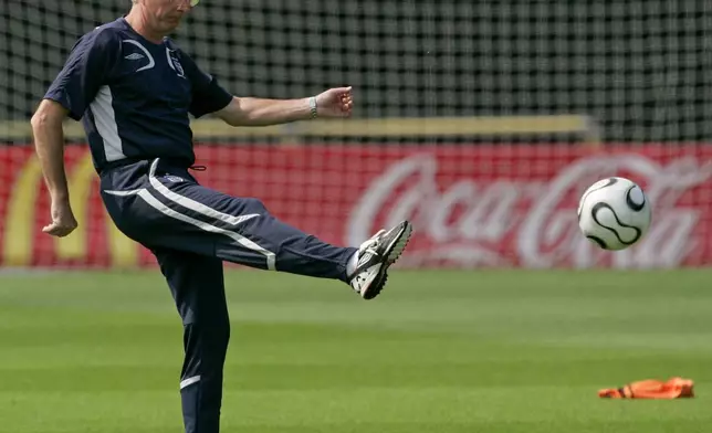 FILE - England national soccer team manager Sven-Goran Eriksson kicks a ball during a squad training session for the World Cup at Mittelbergstadion in Buehlertal, Germany, Thursday June 29, 2006. Eriksson the Swedish soccer manager who spent five years as England’s first ever foreign-born coach, has died. He was 76, it was announced on Monday, Aug. 26, 2024. (AP Photo/Matt Dunham, File)