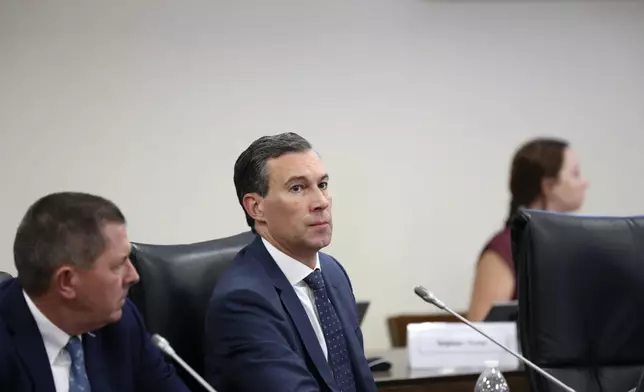 Duke Energy's utility operations in South Carolina President Mike Callahan waits to testify before a South Carolina Senate committee planning to write a comprehensive energy bill in 2025 in Columbia, S.C., on Thursday, Aug. 22 2024. (AP Photo/Jeffrey Collins)