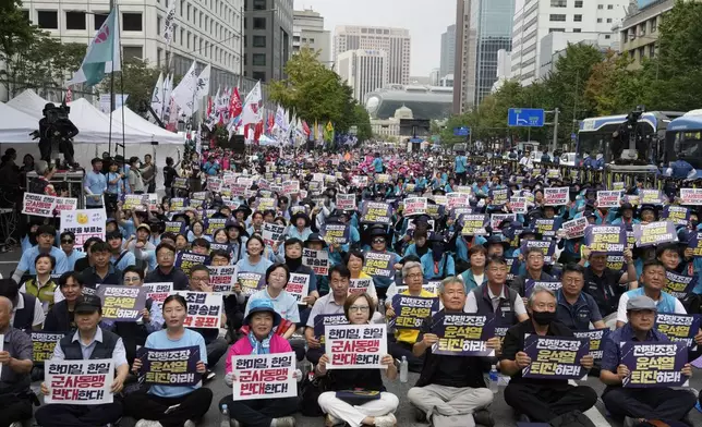 South Korean protesters stage a rally opposing the joint military exercises between the U.S. and South Korea in Seoul, South Korea, Saturday, Aug. 10, 2024. The banners read "Stop the South Korea - U.S. - Japan military alliance."(AP Photo/Ahn Young-joon)