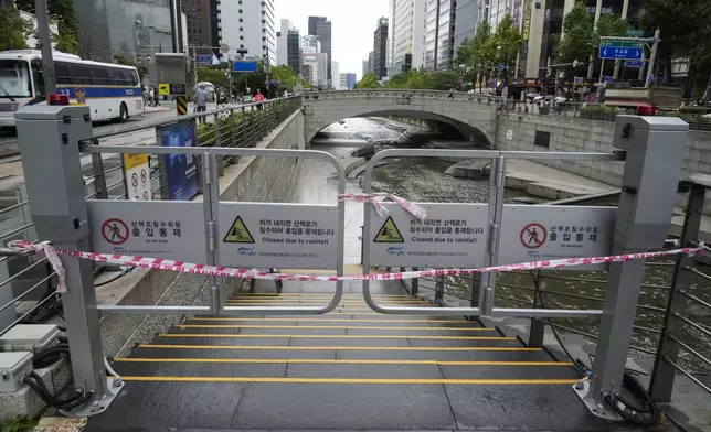 An entrance to the Cheonggye stream is closed in preparation for an approaching Tropical Storm Jongdari in Seoul, South Korea, Wednesday, Aug. 21, 2024. (AP Photo/Ahn Young-joon)