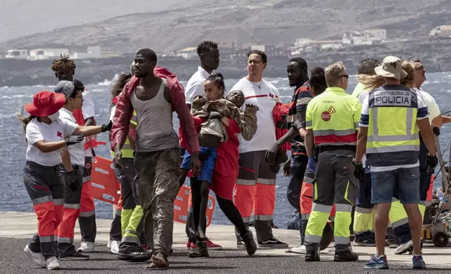 Migrants disembark at the port of "La Estaca" in Valverde at the Canary island of El Hierro, Spain, Monday, Aug. 26, 2024. Emergency services say migrants arrived by boat after a thirteen-day voyage from the coast of Senegal. (AP Photo/Maria Ximena)