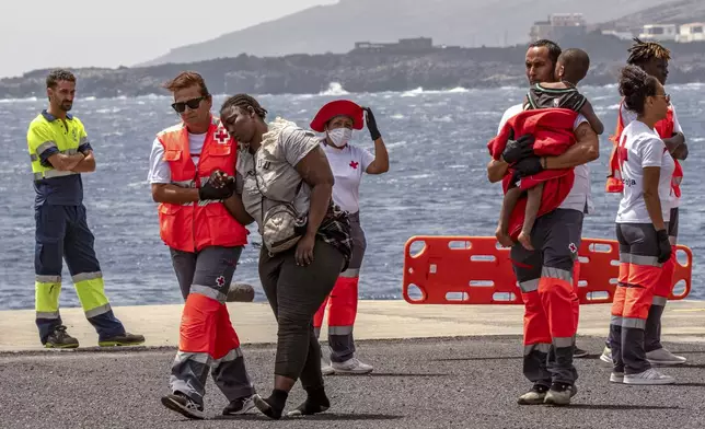 Migrants disembark at the port of "La Estaca" in Valverde at the Canary island of El Hierro, Spain, Monday, Aug. 26, 2024, after a thirteen-day voyage by boat from the coast of Senegal. (AP Photo/Maria Ximena)