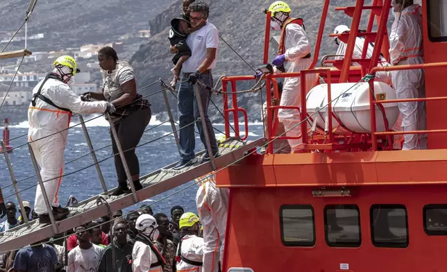 Migrants disembark at the port of "La Estaca" in Valverde at the Canary island of El Hierro, Spain, Monday, Aug. 26, 2024. Migrants arrived by boat after a thirteen-day voyage from the coast of Senegal. (AP Photo/Maria Ximena)