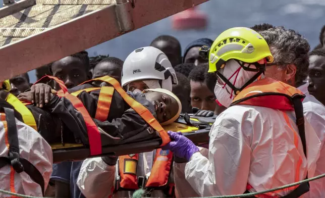 Migrants disembark at the port of "La Estaca" in Valverde at the Canary island of El Hierro, Spain, Monday, Aug. 26, 2024, after a thirteen-day voyage by boat from the coast of Senegal. (AP Photo/Maria Ximena)