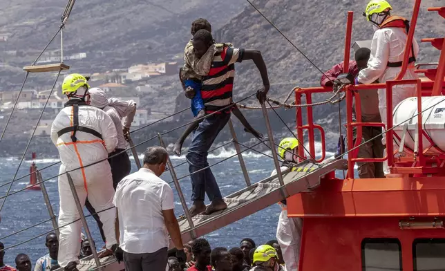 Migrants disembark at the port of "La Estaca" in Valverde at the Canary island of El Hierro, Spain, Monday, Aug. 26, 2024, after they arrived by boat from a thirteen-day voyage from the coast of Senegal. (AP Photo/Maria Ximena)