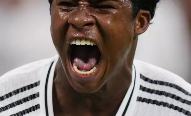 Real Madrid's Endrick celebrates after scoring his side's third goal during the Spanish La Liga soccer match between Real Madrid and Valladolid at the Santiago Bernabeu stadium in Madrid, Spain, Sunday, Aug. 25, 2024. (AP Photo/Manu Fernandez)