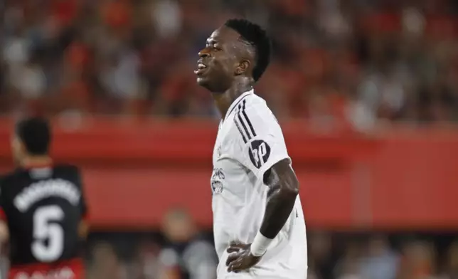 Real Madrid's Vinicius Junior reacts during a Spanish La Liga soccer match between Mallorca and Real Madrid at the Son Moix Stadium in Palma de Mallorca, Spain, Sunday, Aug. 18, 2024. (AP Photo/Francisco Ubilla)