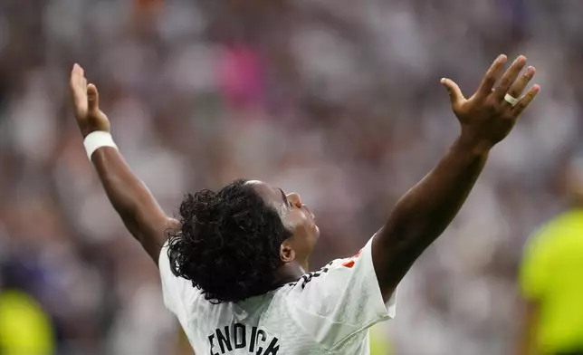 Real Madrid's Endrick celebrates after scoring his side's third goal during the Spanish La Liga soccer match between Real Madrid and Valladolid at the Santiago Bernabeu stadium in Madrid, Spain, Sunday, Aug. 25, 2024. (AP Photo/Manu Fernandez)