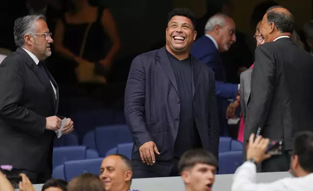 Real Madrid's and Brazil soccer player, Valladolid's owner Ronaldo Nazario de Lima smiles the Spanish La Liga soccer match between Real Madrid and Valladolid at the Santiago Bernabeu stadium in Madrid, Spain, Sunday, Aug. 25, 2024. (AP Photo/Manu Fernandez)