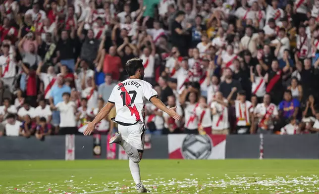 Rayo's Unai Lopez celebrates after scoring his side's opening goal during the Spanish La Liga soccer match between Rayo Vallecano and Barcelona at the Vallecas stadium in Madrid, Spain, Tuesday, Aug. 27, 2024. (AP Photo/Manu Fernandez)