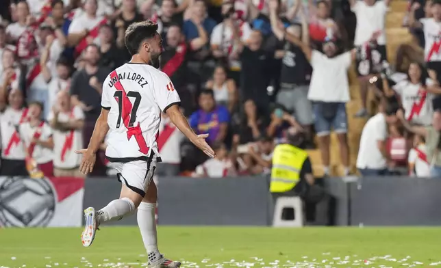Rayo's Unai Lopez celebrates after scoring his side's opening goal during the Spanish La Liga soccer match between Rayo Vallecano and Barcelona at the Vallecas stadium in Madrid, Spain, Tuesday, Aug. 27, 2024. (AP Photo/Manu Fernandez)