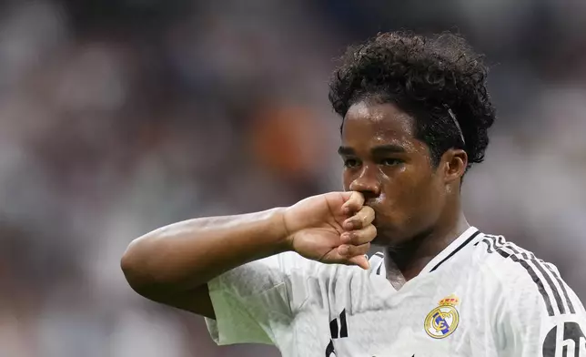 Real Madrid's Endrick celebrates after scoring his side's third goal during the Spanish La Liga soccer match between Real Madrid and Valladolid at the Santiago Bernabeu stadium in Madrid, Spain, Sunday, Aug. 25, 2024. (AP Photo/Manu Fernandez)