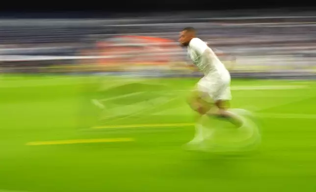 Real Madrid's Kylian Mbappe warms up before the Spanish La Liga soccer match between Real Madrid and Valladolid at the Santiago Bernabeu stadium in Madrid, Spain, Sunday, Aug. 25, 2024. (AP Photo/Manu Fernandez)