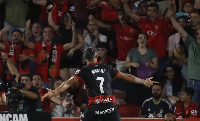 Mallorca's Vedat Muriqi celebrates after scoring his side's first goal during a Spanish La Liga soccer match between Mallorca and Real Madrid at the Son Moix Stadium in Palma de Mallorca, Spain, Sunday, Aug. 18, 2024. (AP Photo/Francisco Ubilla)