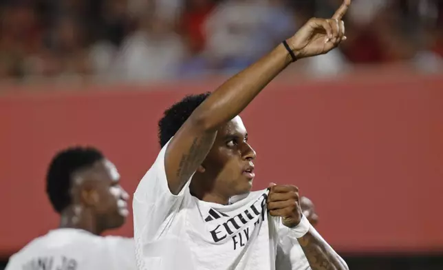 Real Madrid's Rodrygo celebrates after scoring the opening goal during a Spanish La Liga soccer match between Mallorca and Real Madrid at the Son Moix Stadium in Palma de Mallorca, Spain, Sunday, Aug. 18, 2024. (AP Photo/Francisco Ubilla)