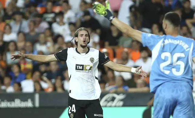 Valencia's Yarek Gasiorowski reacts during the Spanish La Liga soccer match between Valencia and FC Barcelona at the Mestalla stadium in Valencia, Spain, Saturday, Aug. 17, 2024. (AP Photo/Alberto Saiz)