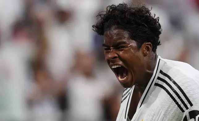 Real Madrid's Endrick celebrates after scoring his side's third goal during the Spanish La Liga soccer match between Real Madrid and Valladolid at the Santiago Bernabeu stadium in Madrid, Spain, Sunday, Aug. 25, 2024. (AP Photo/Manu Fernandez)